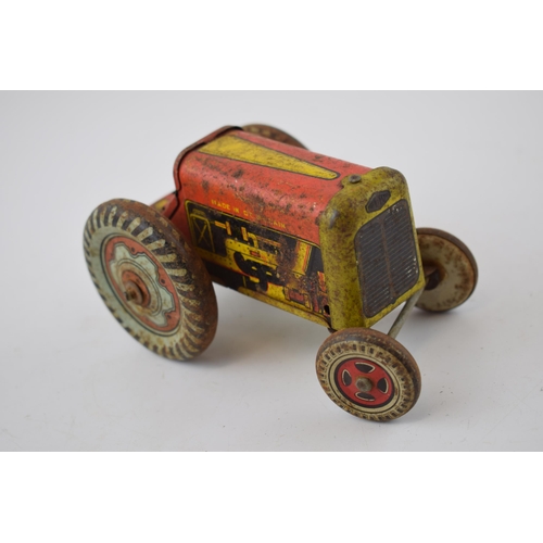 663 - Mettoy tinplate model of a tractor, with blue wheels and a red body, with a vintage tin plate 'Rainb... 