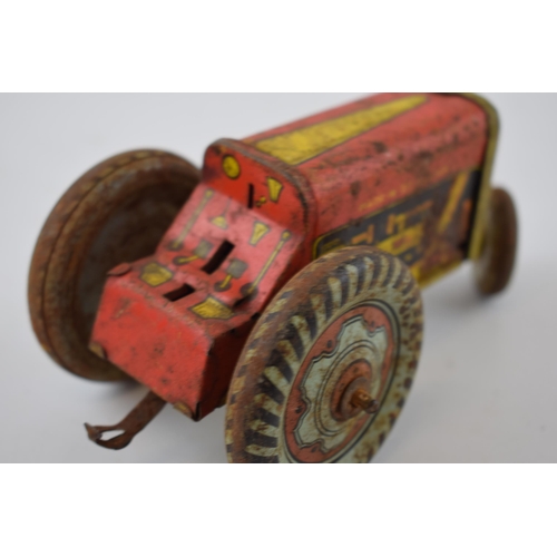 663 - Mettoy tinplate model of a tractor, with blue wheels and a red body, with a vintage tin plate 'Rainb... 