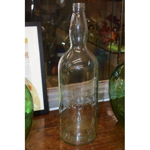 697 - A pair of large Viresa green glass carboys, 35cm tall, together with a Bells Scotch Whisky bottle (3... 