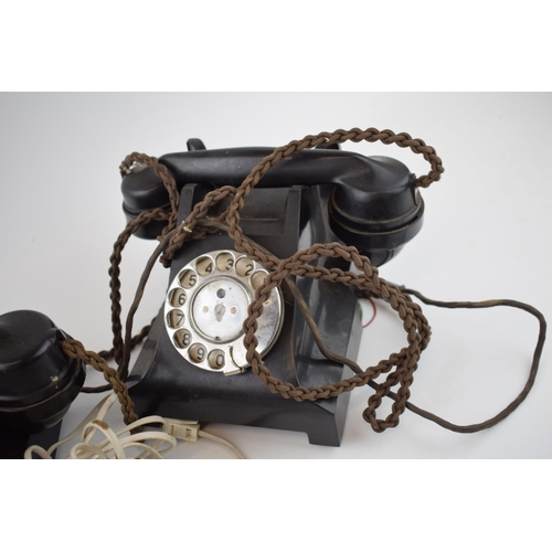 701 - A pair of vintage black Bakelite telephones with wires (2).