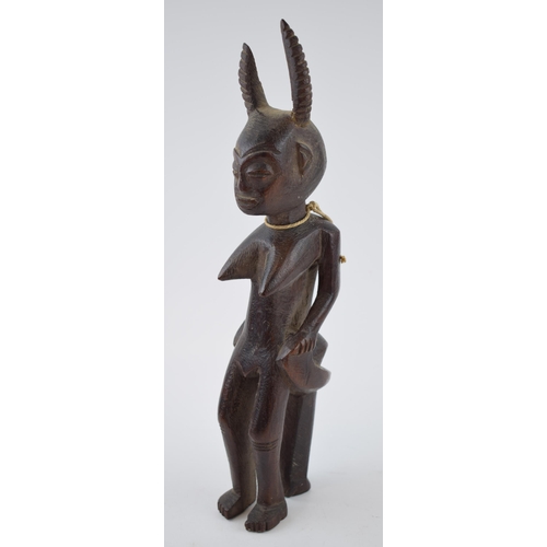 704 - Tribal 19th century wood carving sculpture possibly of West African decent. Height 33cm.