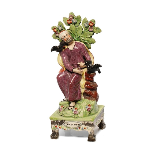 187 - An early 19th century Staffordshire pearlware bocage figure of Elijah on table base, c. 1820. 31 cm ... 