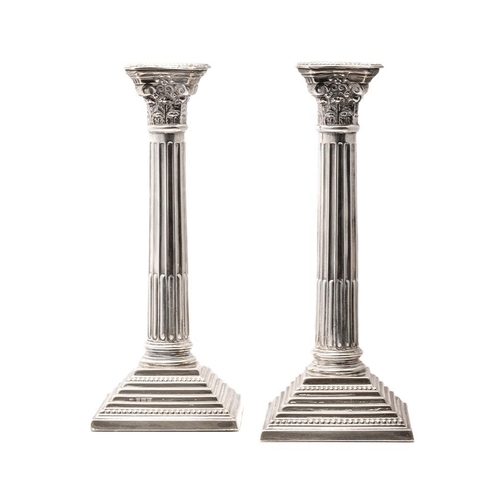 407 - Pair of corinthian column candlesticks  with weighted bases. Sterling silver. Hallmarked Birmingham,... 