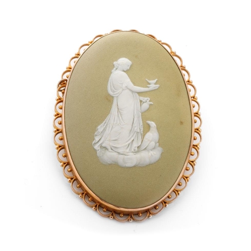 487 - 9ct gold framed Wedgwood cameo in early lime green colourway depicting a lady with a large bird, 65m... 