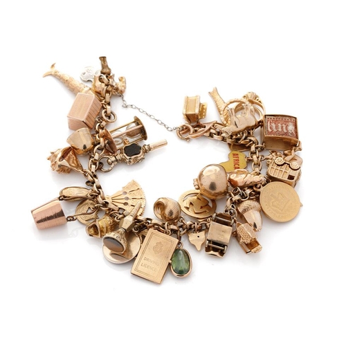 519 - 9ct gold charm bracelet with approximately 44 individual charms. Including a 22ct gold 1/3 Guinea co... 