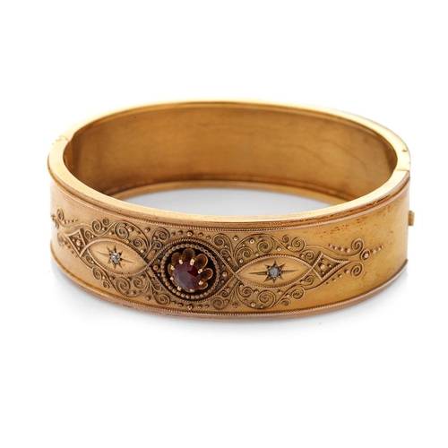 521 - 15ct gold (tests as) Egyptian Revival ladies bangle, set with diamonds and a large garnet with ornat... 