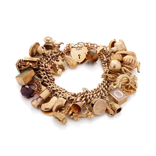 525 - 9ct gold double link charm bracelet, complete with over 40 charms, to include a fob, an eagle's claw... 