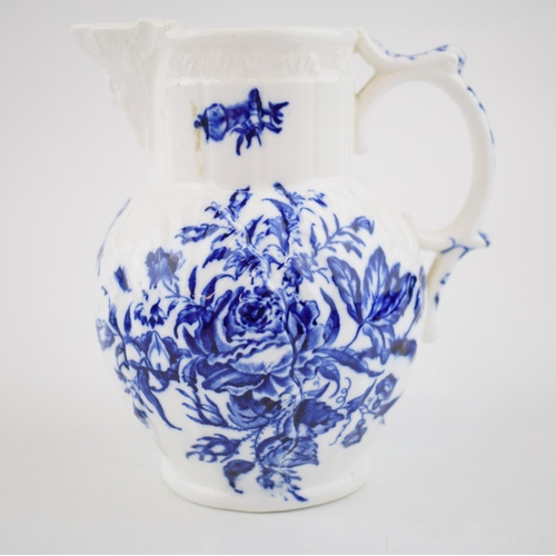 150 - A late 18th, early 19th century blue and white transfer-printed porcelain moulded mask jug decorated... 