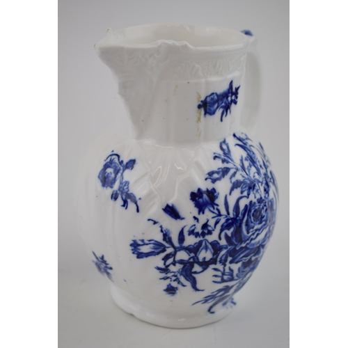 150 - A late 18th, early 19th century blue and white transfer-printed porcelain moulded mask jug decorated... 