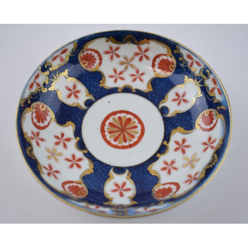 157 - An 18th century Worcester porcelain Japan Star pattern on a blue scale ground cup and saucer, c. 177... 