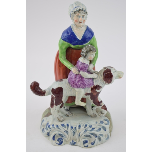 185 - An early 19th century Staffordshire pearlware figure of a grandmother and a child on a dog, c. 1820.... 