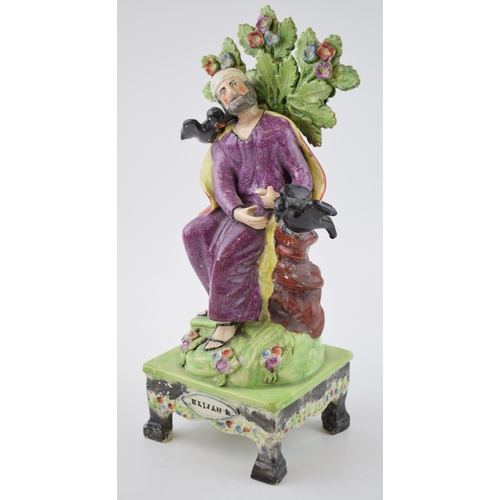 187 - An early 19th century Staffordshire pearlware bocage figure of Elijah on table base, c. 1820. 31 cm ... 