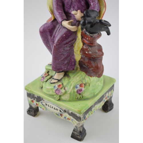 187 - An early 19th century Staffordshire pearlware bocage figure of Elijah on table base, c. 1820. 31 cm ... 