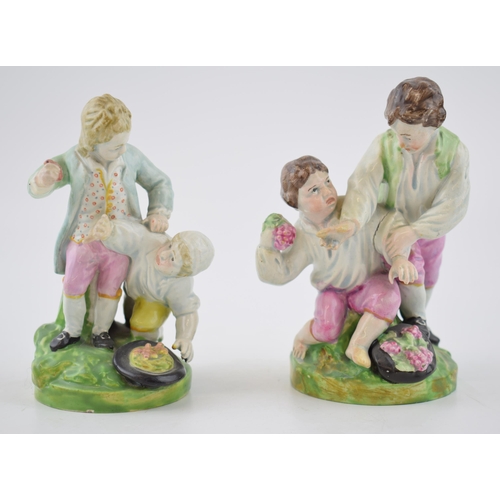 191 - A pair of early 19th century Staffordshire pearlware figures of boys playing, c. 1820. 14 cm tall. (... 