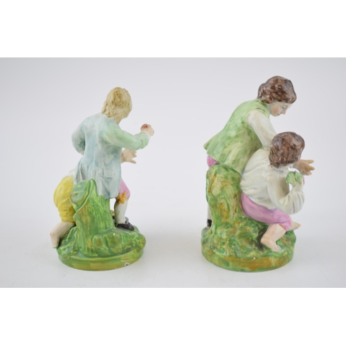 191 - A pair of early 19th century Staffordshire pearlware figures of boys playing, c. 1820. 14 cm tall. (... 