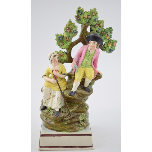 193 - An early 19th century Staffordshire pearlware bocage figure of boy and girl harvesters on square bas... 