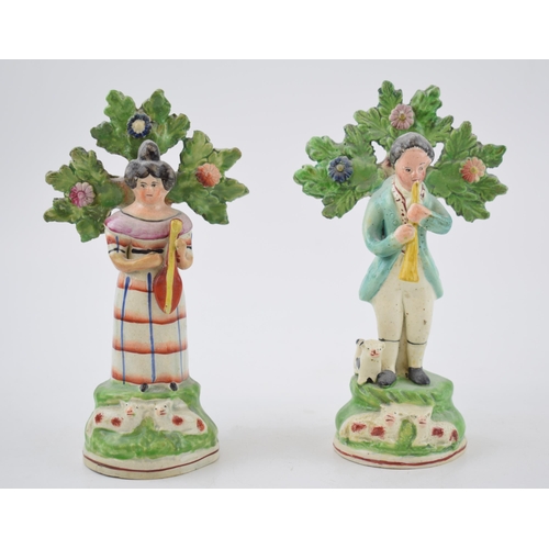 196 - A pair of early 19th century Staffordshire pearlware bocage figures shepherd and shepherdess musicia... 