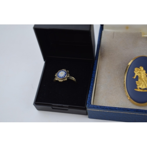 63 - Wedgwood jewellery to include a gold on blue cameo brooch in gilt frame, a gold on silver ring with ... 