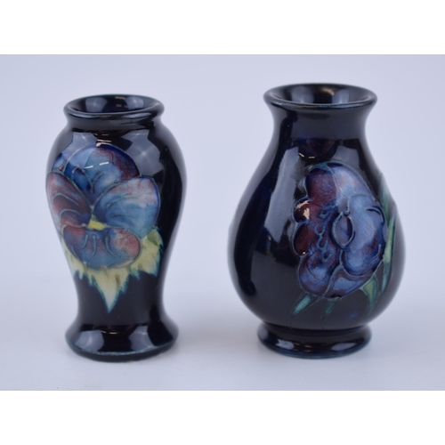 79 - A miniature pair of Moorcroft vases with floral design, 6cm tall (2).