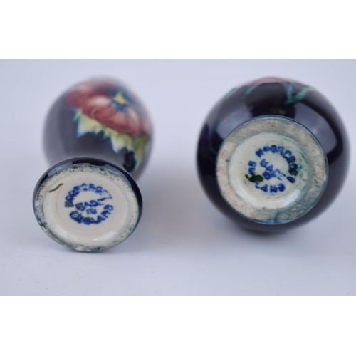 79 - A miniature pair of Moorcroft vases with floral design, 6cm tall (2).