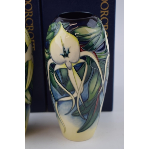 83 - A boxed pair of Moorcroft orchid vases, the first matching pair of vases, one being the Andraecum Or... 