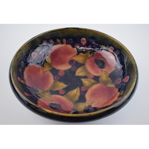 88 - Moorcroft footed bowl decorated in the Pomegranate pattern, 25cm diameter (af).