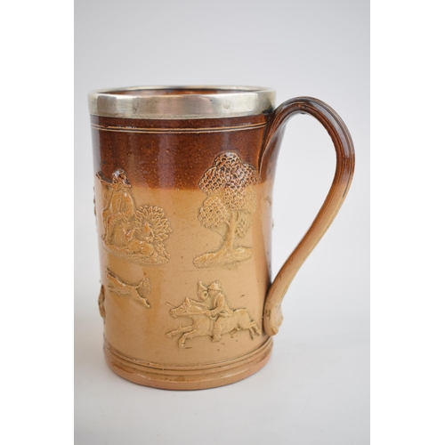 200 - A trio of stoneware items to include a silver rimmed Doulton Lambeth tankard, a large pouring jug, p... 