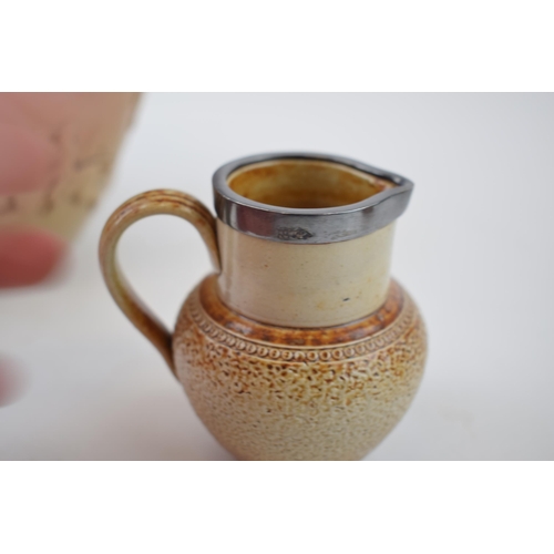 200 - A trio of stoneware items to include a silver rimmed Doulton Lambeth tankard, a large pouring jug, p... 