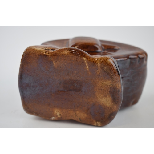 201 - Stoneware treacle-glazed money box in the form of WWI tank. Height 9.5cm.