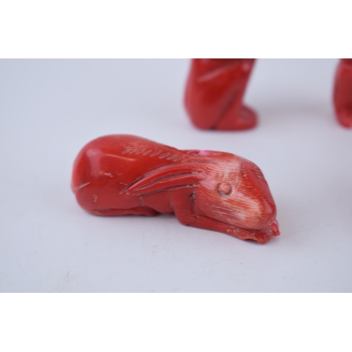 203 - A collection of four oriental red jasper zodiac figures to include a rabbit a ram and two monkeys.He... 