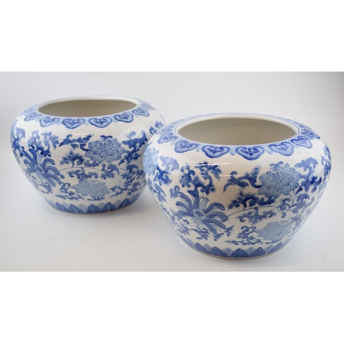 205 - A pair of late 20th century Oriental style jardinieres, blue and white foliage, 31cm diameter (2).