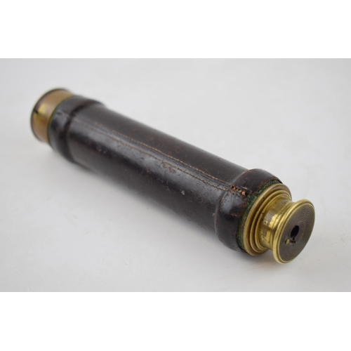 211 - Pocket-sized brass telescope with leather grip. Brass cover to eye-piece. Inscribed 'Charles Pearson... 