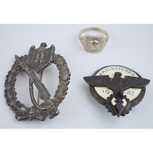 219 - A collection of German military items to include a ring with skull and crossbones marked D.G.R.M and... 