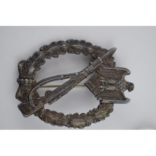 219 - A collection of German military items to include a ring with skull and crossbones marked D.G.R.M and... 