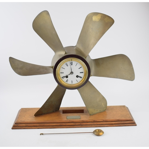 230 - Phosphor bronze propellor with pendulum chiming clock. White ceramic dial with Roman numerals and be... 