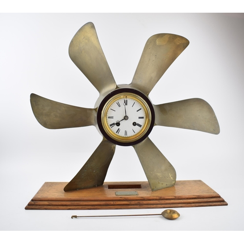 230 - Phosphor bronze propellor with pendulum chiming clock. White ceramic dial with Roman numerals and be... 