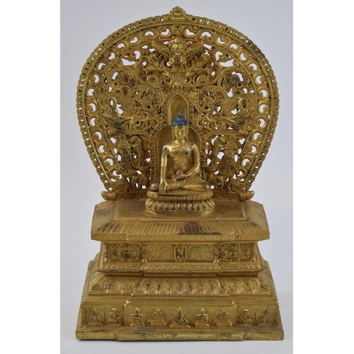 234 - Large reproduction Tibetan gilt bronze figure of a seated Tibetan buddha on a throne, 28cm tall.