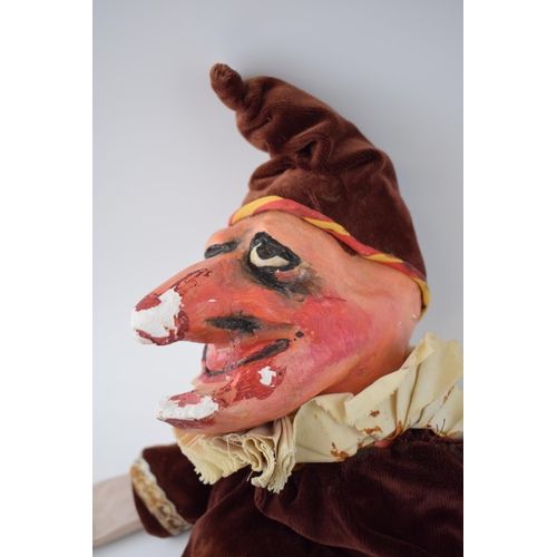 249 - An early 20th century naive plaster hand puppet in the form of Mr Punch in velvet dress with wooden ... 