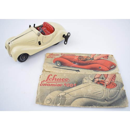 251 - Boxed Schuco Examico 4001 tin toy clockwork car. With four working gears and reverse. Original Schuc... 