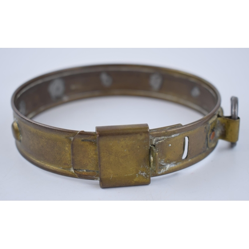 262 - An antique brass dog collar with steel hoop for attaching lead. Diameter 33cm.