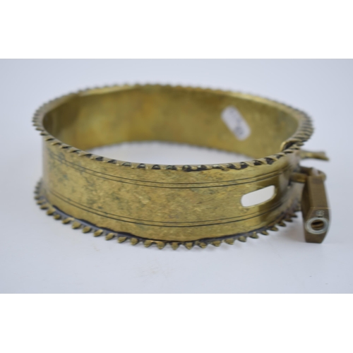 263 - An antique brass dog collar with decorative fixings and raised spiked pattern to outer edge. Diamete... 