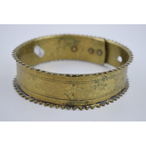 263 - An antique brass dog collar with decorative fixings and raised spiked pattern to outer edge. Diamete... 