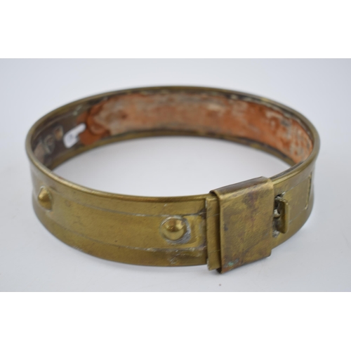 265 - An antique brass dog collar with ball decoration and sliding buckle.  Diameter 46cm.