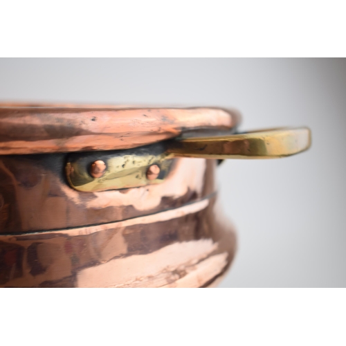 266 - Large Victorian copper basket with riveted joints with brass handles, 53cm diameter.