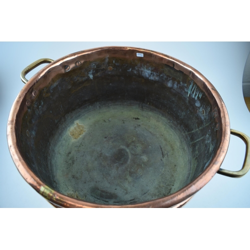 266 - Large Victorian copper basket with riveted joints with brass handles, 53cm diameter.