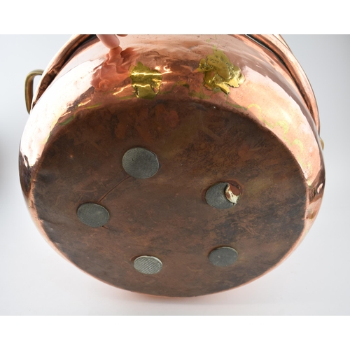 266 - Large Victorian copper basket with riveted joints with brass handles, 53cm diameter.