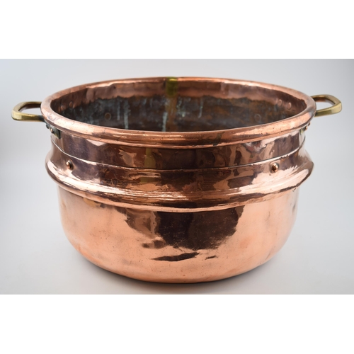 266 - Large Victorian copper basket with riveted joints with brass handles, 53cm diameter.