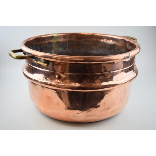 266 - Large Victorian copper basket with riveted joints with brass handles, 53cm diameter.