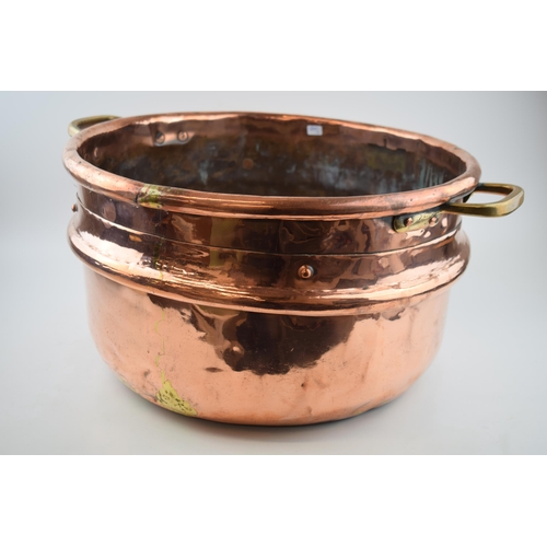 266 - Large Victorian copper basket with riveted joints with brass handles, 53cm diameter.