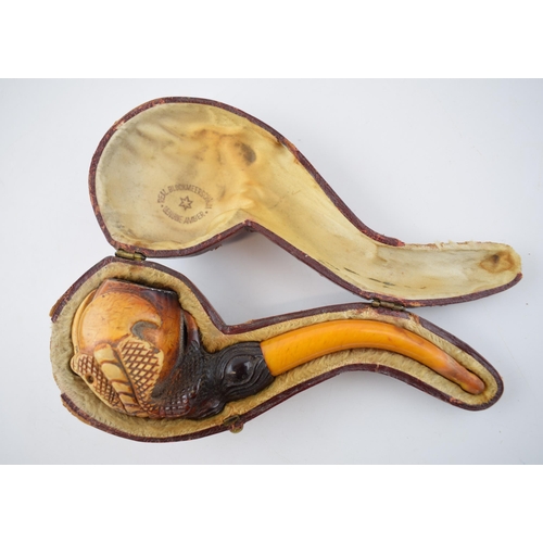 268 - Cased early 20th century meerschaum smoking pipe in the form of a ball and claw with amber handle, i... 